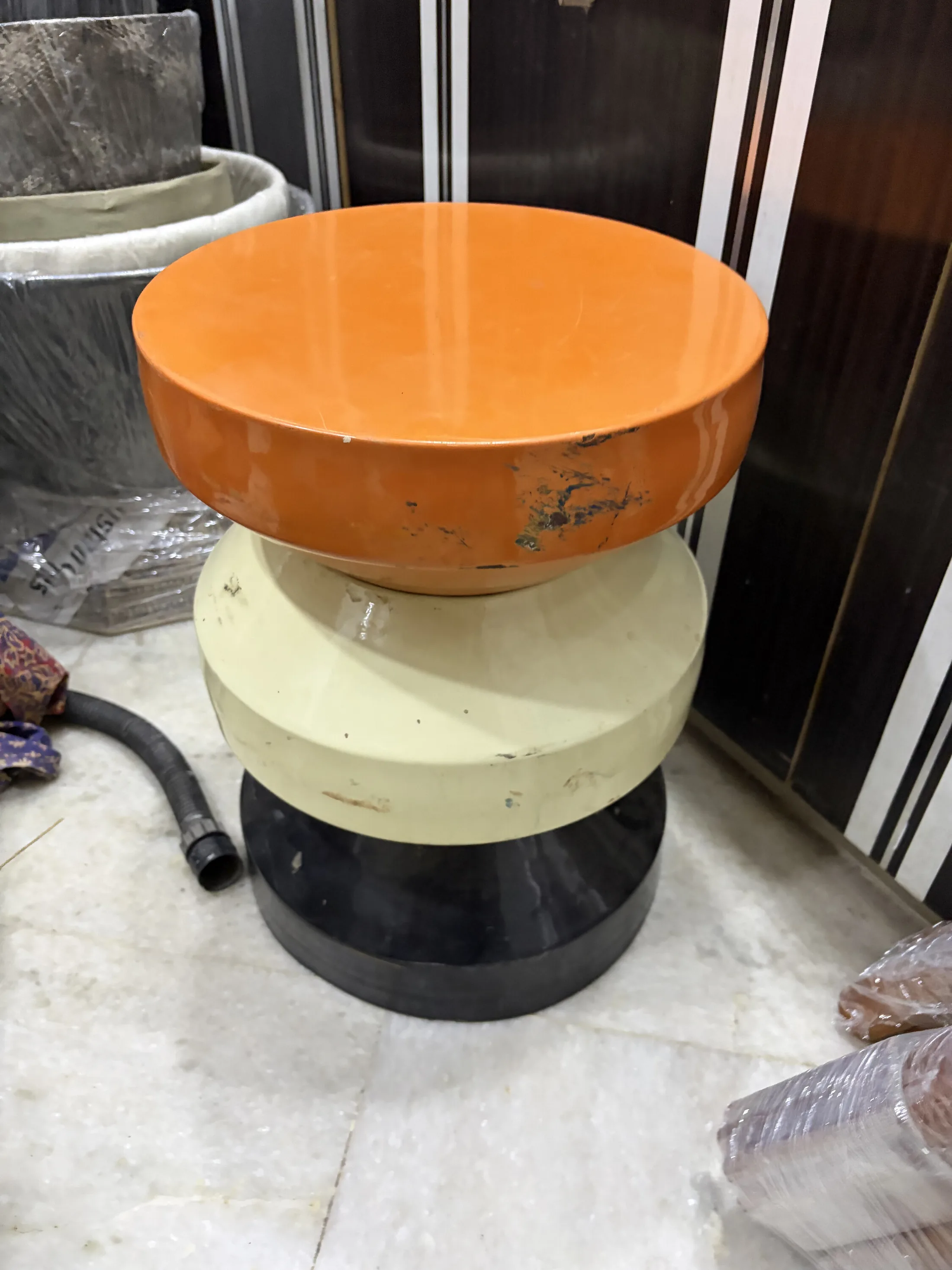 Orange Cream and Black Stacked Round Side Stool — Furniture prop for rent in Delhi NCR