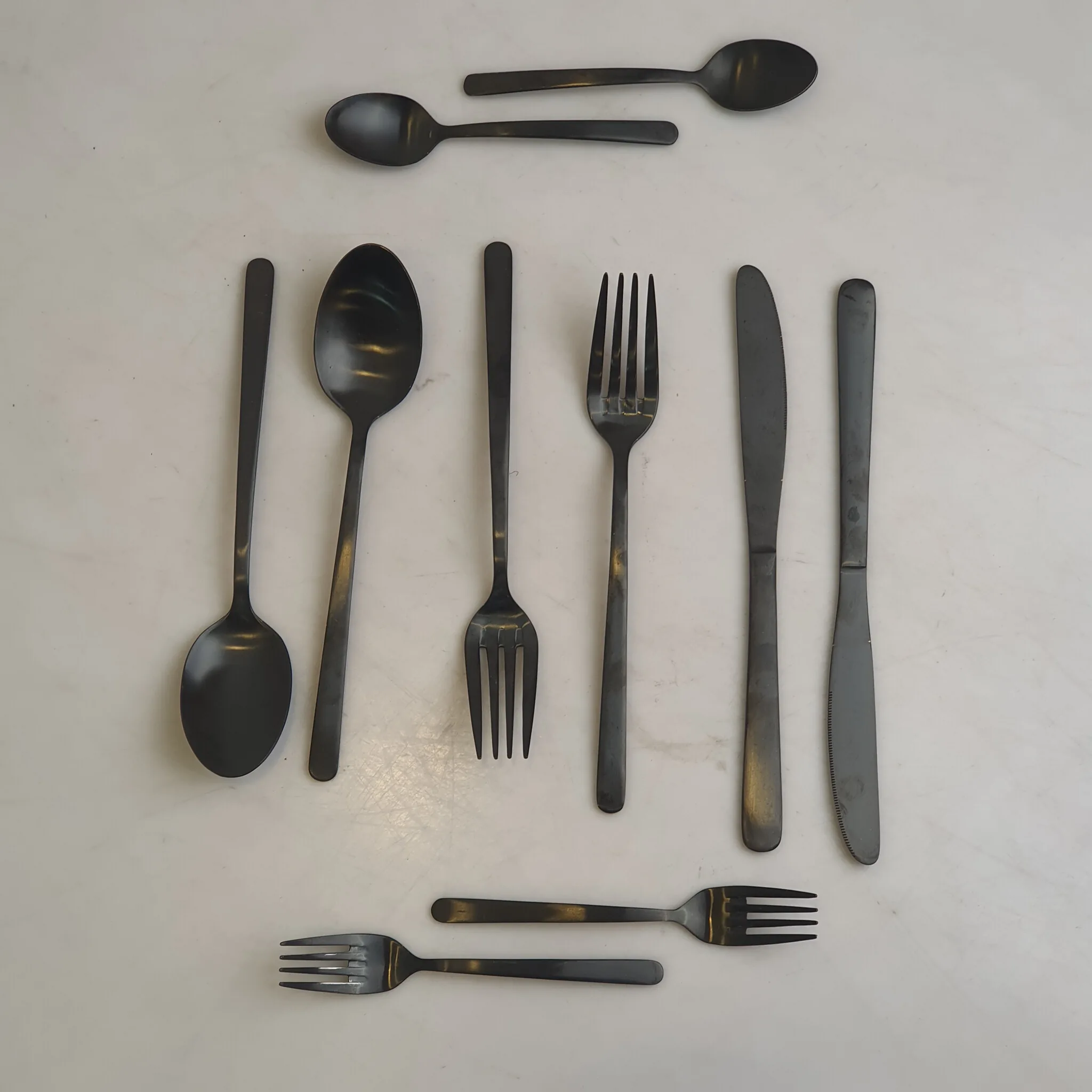 Matte Black Stainless Steel Cutlery Set — Kitchen and Dining prop for rent in Delhi NCR