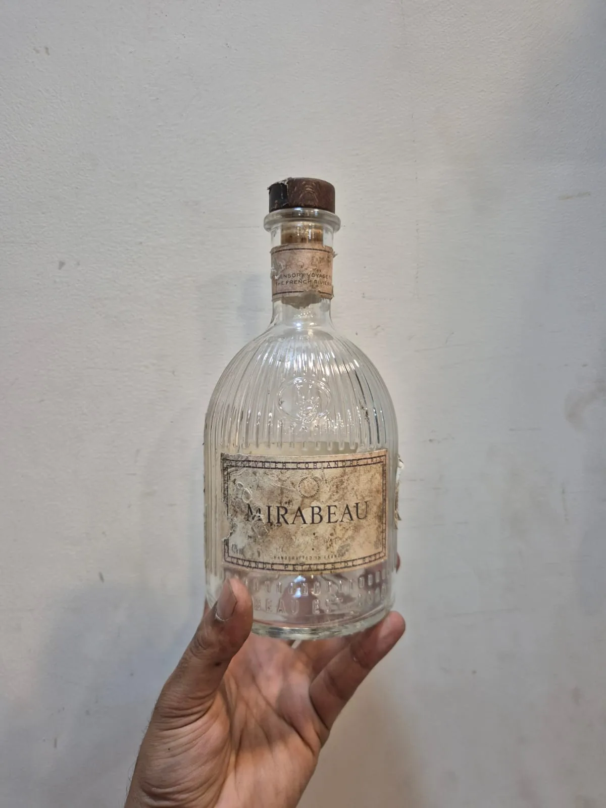 Mirabeau Gin Bottle Ribbed Glass Aged Label Cork Stopper — Bar and Glassware prop for rent in Delhi NCR