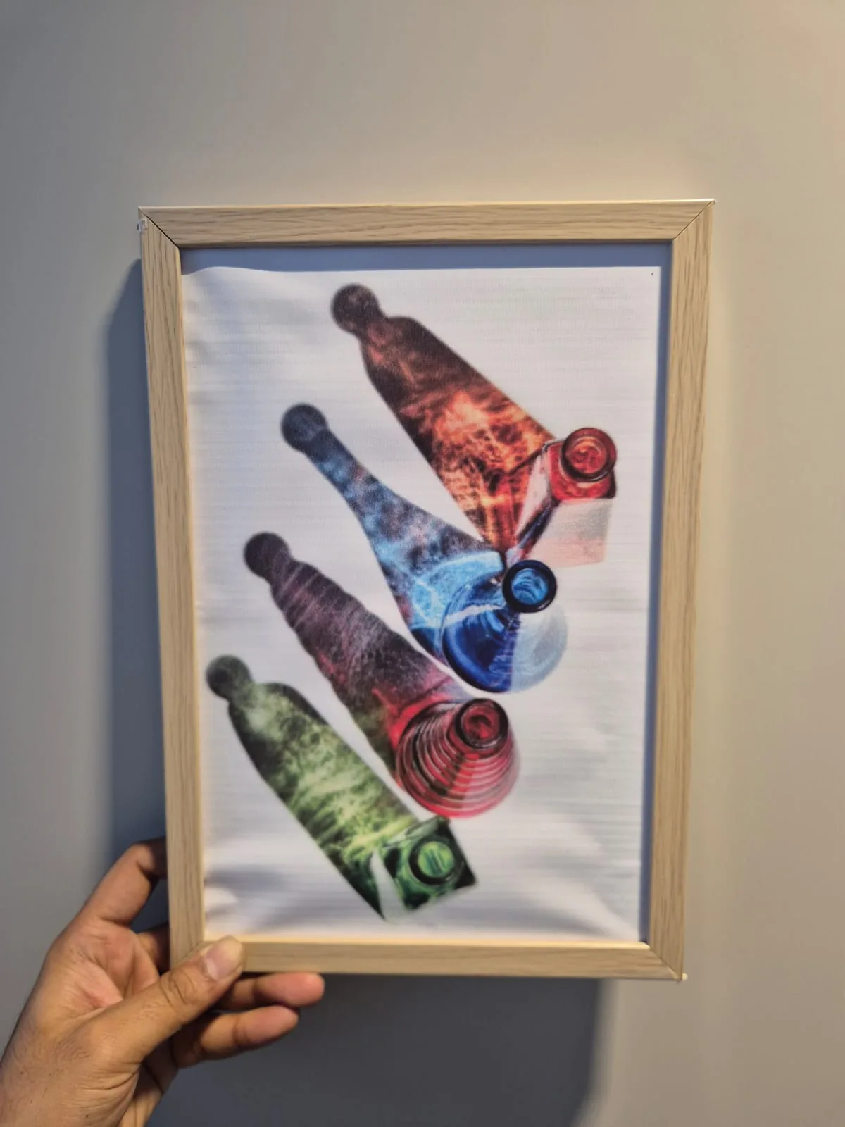Modern Colorful Falling Glass Bottles Framed Wall Art 8.5 x 12.5 in — Wall Decor and Art prop for rent in Delhi NCR