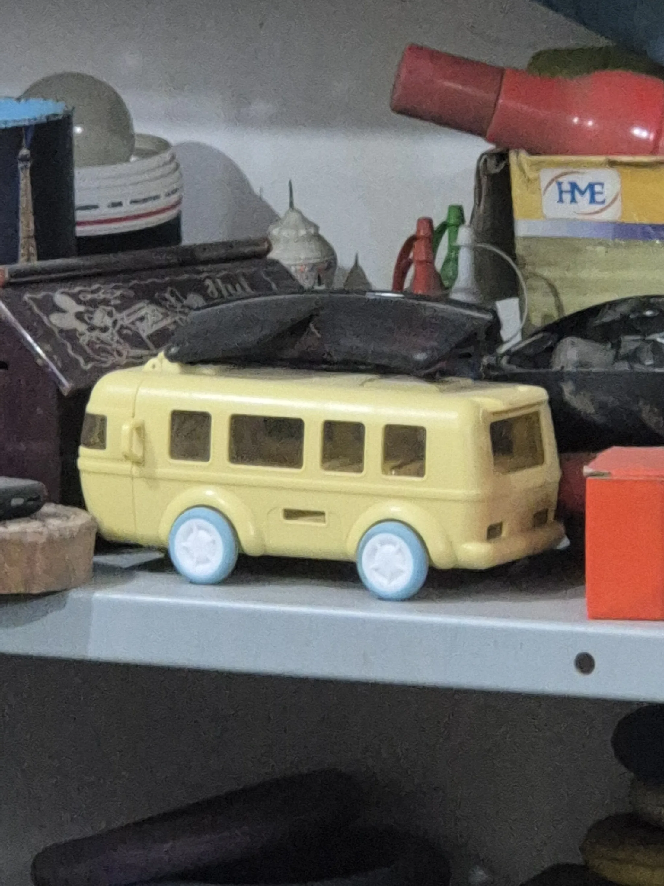 Pale Yellow Toy Camper Van with Blue Wheels — Toys and Games prop for rent in Delhi NCR