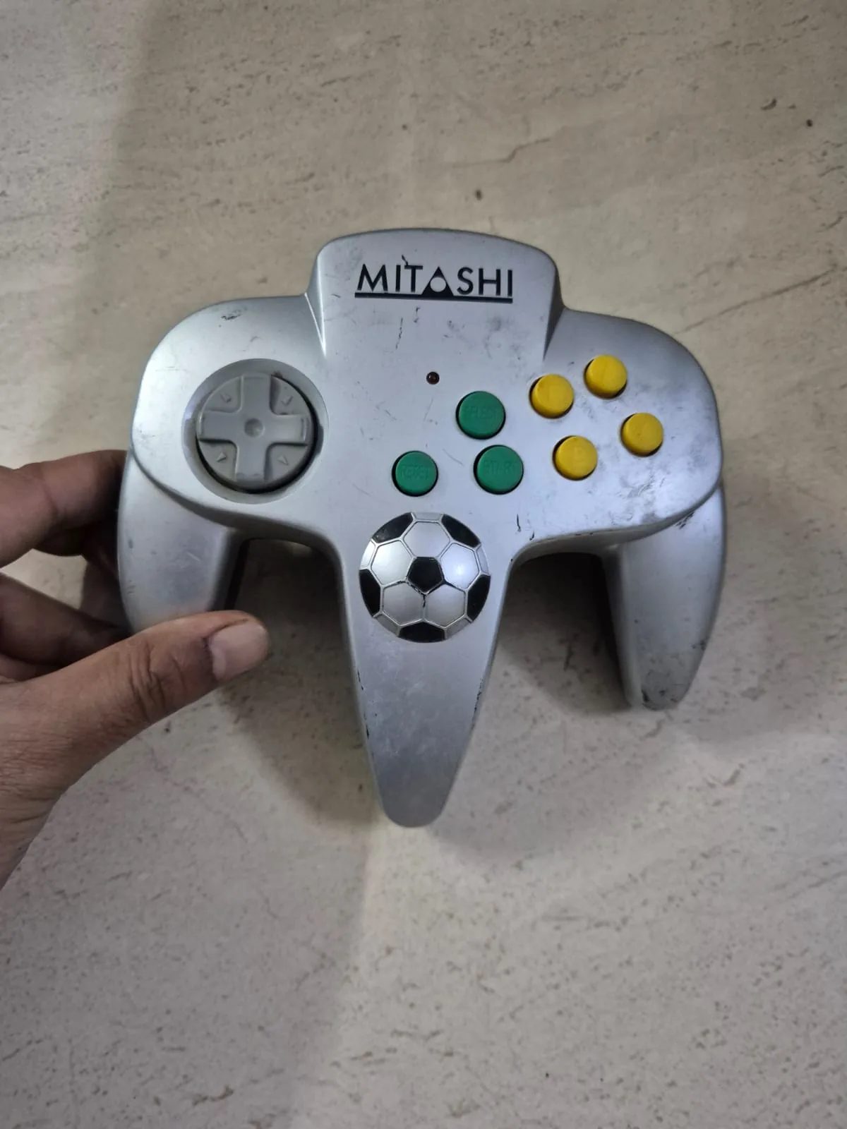 Vintage Silver Mitashi N64 Style Soccer Game Controller — Toys and Games prop for rent in Delhi NCR